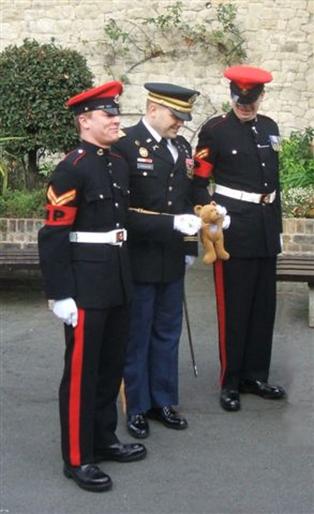 Two Military Policemen and an Officer with mascot - a teddy bear
